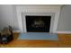 Close-up view of a fireplace with a decorative mantle and a pile of firewood at 1106 N Hartman Dr, Indianapolis, IN 46219