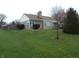 Single-story home with stone and siding exterior, mature trees, and well-maintained lawn at 1106 N Hartman Dr, Indianapolis, IN 46219