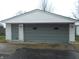 Spacious detached garage with painted siding, a pedestrian door, and ample room for vehicles at 1106 N Hartman Dr, Indianapolis, IN 46219