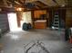 Unfinished garage with cabinets and visible framing at 1106 N Hartman Dr, Indianapolis, IN 46219