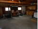 Spacious unfinished garage with visible framing and natural light at 1106 N Hartman Dr, Indianapolis, IN 46219
