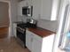 Beautiful kitchen space with stainless appliances and wood countertops at 1106 N Hartman Dr, Indianapolis, IN 46219