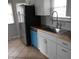 Bright kitchen with stainless steel appliances and tile floors at 1106 N Hartman Dr, Indianapolis, IN 46219