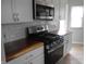 Well-equipped kitchen featuring gas range and stainless steel microwave at 1106 N Hartman Dr, Indianapolis, IN 46219