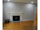Spacious living room featuring hardwood floors and a fireplace with white mantle at 1106 N Hartman Dr, Indianapolis, IN 46219