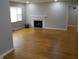 Inviting living room featuring hardwood floors, fireplace, and ample natural light at 1106 N Hartman Dr, Indianapolis, IN 46219