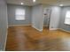 Open living room with hardwood floors, multiple windows, and access to other rooms at 1106 N Hartman Dr, Indianapolis, IN 46219
