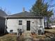 Exterior view of a gray house featuring a black door, gray shingles and an AC Unit at 1153 W 29Th St, Indianapolis, IN 46208