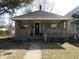 Charming single-story home featuring a covered front porch with classic architectural details at 1153 W 29Th St, Indianapolis, IN 46208
