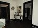 Hallway featuring dark wooden floors and modern wall decor at 1153 W 29Th St, Indianapolis, IN 46208