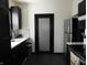Contemporary kitchen with sleek dark cabinets, stainless steel fridge, and a tiled backsplash at 1153 W 29Th St, Indianapolis, IN 46208