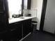 Bright kitchen featuring a stainless steel sink, dark cabinets, and modern faucet at 1153 W 29Th St, Indianapolis, IN 46208