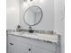 Modern bathroom featuring white granite countertops, vanity and updated light fixture at 1160 Ida Ct, Greenwood, IN 46143