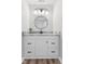 Bathroom vanity with granite countertops, undermount sink, modern fixtures, and stylish round mirror at 1160 Ida Ct, Greenwood, IN 46143
