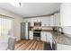 Open kitchen with stainless appliances, granite counters, white cabinets and lots of natural light at 1160 Ida Ct, Greenwood, IN 46143