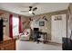 A bedroom featuring a ceiling fan, a desk, a chair, and Indiana Pacers decor at 11629 Boothbay Ln, Fishers, IN 46037