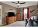Cozy bedroom features a comfortable seating area and natural light at 11629 Boothbay Ln, Fishers, IN 46037