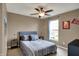 Cozy bedroom with natural light from the window and a neutral color palette at 11629 Boothbay Ln, Fishers, IN 46037
