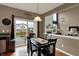 Cozy dining area with sliding glass doors leading to the backyard and views into the living room at 11629 Boothbay Ln, Fishers, IN 46037