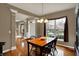 Charming dining room with hardwood flooring, ample lighting, and a view to the home's entry at 11629 Boothbay Ln, Fishers, IN 46037