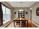 Cozy dining room featuring hardwood floors, large window and a hutch at 11629 Boothbay Ln, Fishers, IN 46037