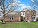 Charming two-story brick home featuring a well-manicured lawn and welcoming front entrance at 11629 Boothbay Ln, Fishers, IN 46037
