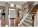 Bright foyer showcasing hardwood floors, staircase, and entry door with transom window at 11629 Boothbay Ln, Fishers, IN 46037