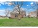 Charming two-story brick home with a well-maintained lawn and landscaping on a beautiful, partly cloudy day at 11629 Boothbay Ln, Fishers, IN 46037