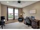 Bright home office featuring a ceiling fan, natural light, and a comfortable workspace at 11629 Boothbay Ln, Fishers, IN 46037