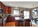 Well-appointed kitchen island with stainless steel appliances, granite countertops and a view to the dining area at 11629 Boothbay Ln, Fishers, IN 46037