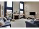 Spacious living room with high ceilings, lots of windows, and a cozy fireplace at 11629 Boothbay Ln, Fishers, IN 46037