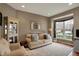 Cozy living room with a large window, neutral tones, and plush carpeting at 11629 Boothbay Ln, Fishers, IN 46037
