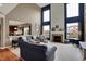 Spacious living room features a fireplace and soaring ceilings with large windows for natural light at 11629 Boothbay Ln, Fishers, IN 46037