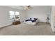 Spacious bedroom with a ceiling fan, cozy carpet, and a large window allowing natural light at 12198 Blue Springs Ln, Fishers, IN 46037