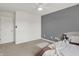 Bedroom featuring a gray accent wall, carpet, and a large window at 12198 Blue Springs Ln, Fishers, IN 46037