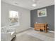 Comfortable bedroom with ample light featuring a desk, chair, and white armchair at 12198 Blue Springs Ln, Fishers, IN 46037