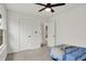 Bright bedroom boasts neutral carpet, a ceiling fan, and a view into the hall at 12198 Blue Springs Ln, Fishers, IN 46037
