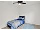 Cozy bedroom features a ceiling fan, blue bedding, and a throw rug on the carpet at 12198 Blue Springs Ln, Fishers, IN 46037
