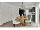 Charming dining area with seating for three, adjacent to a kitchen with modern, green cabinetry at 12198 Blue Springs Ln, Fishers, IN 46037