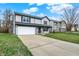 Charming two-story home featuring a two-car garage and well-maintained lawn on a sunny day at 12198 Blue Springs Ln, Fishers, IN 46037