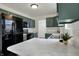 Well-equipped kitchen featuring modern appliances, green cabinets, and sleek countertops for culinary enthusiasts at 12198 Blue Springs Ln, Fishers, IN 46037