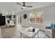 Bright living room with an adjacent kitchen featuring white countertops and backyard views at 12198 Blue Springs Ln, Fishers, IN 46037