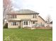 A spacious backyard featuring a well-maintained lawn, a wooden deck, and a neutral tan colored siding at 12441 Bent Oak Ln, Indianapolis, IN 46236