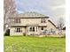 A spacious backyard with a large deck, a lush green lawn, and a view of the home's back exterior at 12441 Bent Oak Ln, Indianapolis, IN 46236