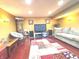 Recreation room in basement, featuring a large screen television and sofa on a stylish rug on hard wood floors at 12441 Bent Oak Ln, Indianapolis, IN 46236