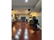 Finished basement with hardwood floors, recessed lighting, a sectional couch, gym equipment, and decor shelving at 12441 Bent Oak Ln, Indianapolis, IN 46236