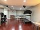 Basement featuring home gym equipment, ping pong table, hardwood floors, and seating area at 12441 Bent Oak Ln, Indianapolis, IN 46236