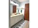 Bathroom featuring double sinks with updated fixtures and a decorative rug at 12441 Bent Oak Ln, Indianapolis, IN 46236