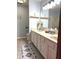 Updated bathroom with a double vanity, framed mirror, and modern decor at 12441 Bent Oak Ln, Indianapolis, IN 46236
