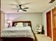Bedroom with carpet, dark wood furnishings, a large bed with decorative pillows, and a patterned accent chair at 12441 Bent Oak Ln, Indianapolis, IN 46236